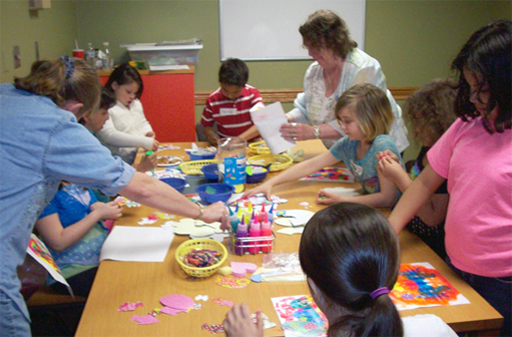 Photo of families working on a creative project at Maryland Public Library