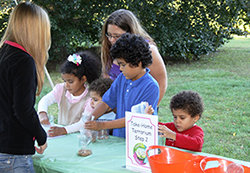 photo of children and families at a NURTURES free and experiential SCI-Fun Community event at partner locations such as the Toledo Botanical Garden, University of Toledo Ritter Planetarium, and the Toledo Zoo.