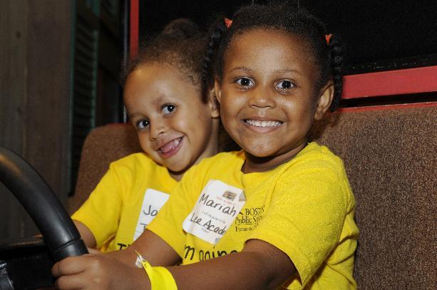 Two incoming kindergarteners try out the school bus exhibit at the Countdown to Kindergarten Celebration held at Boston Children’s Museum. 