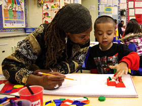 photo of mom helping her preschool son with math