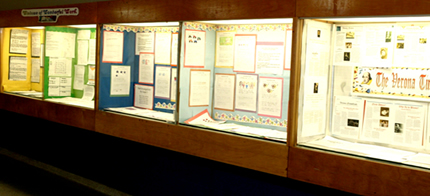 A row of student work on display on a wall panel